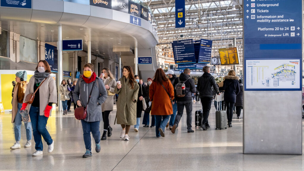 People wearing masks in a London station