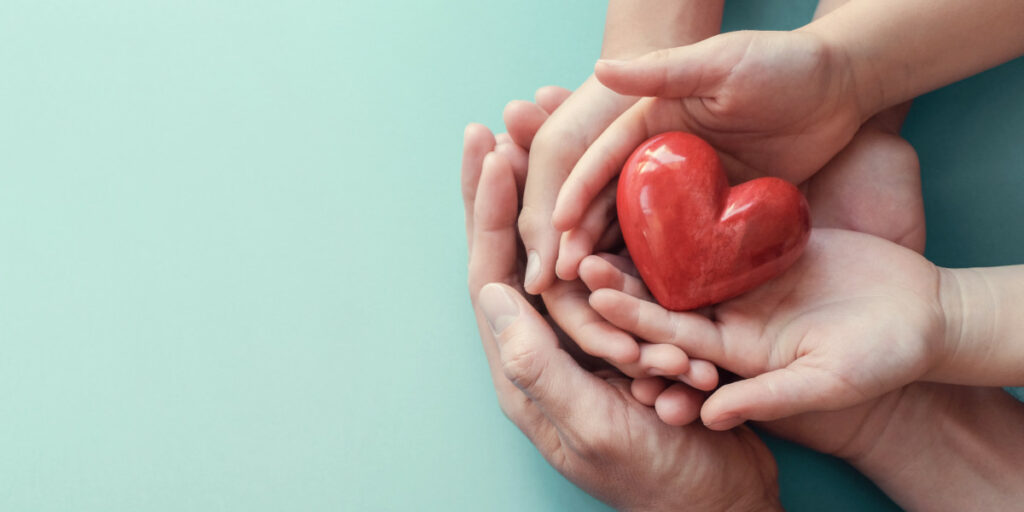 Hands holding a heart, representing a health service. Image is intended to represent the Health Studies User Conference 2024.